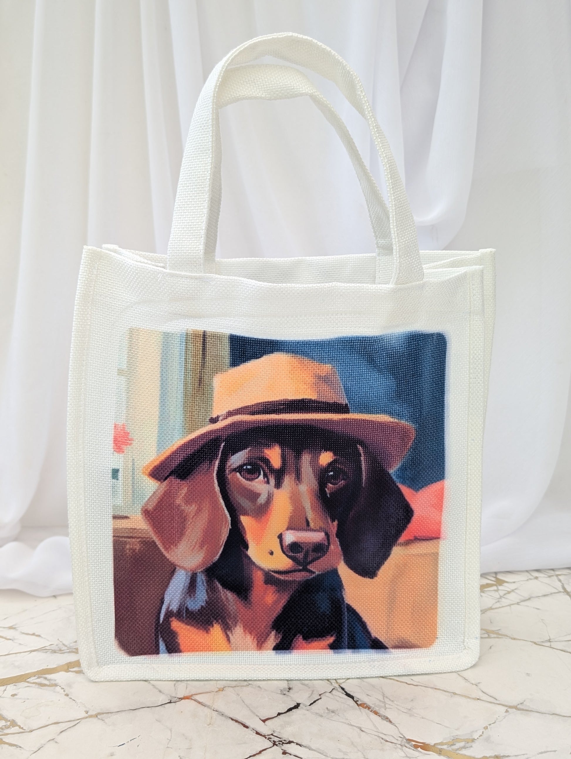 Sausage Dog Gift - Tote bag with a dachshund wearing a Trilbhy hat on a marble surface