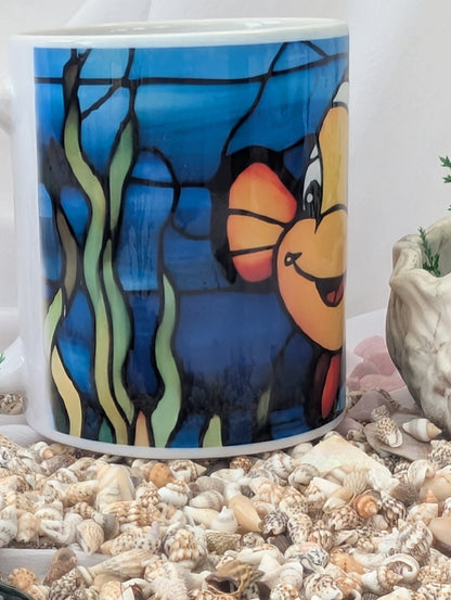 Mug with cartoon character design on a bed of seashells