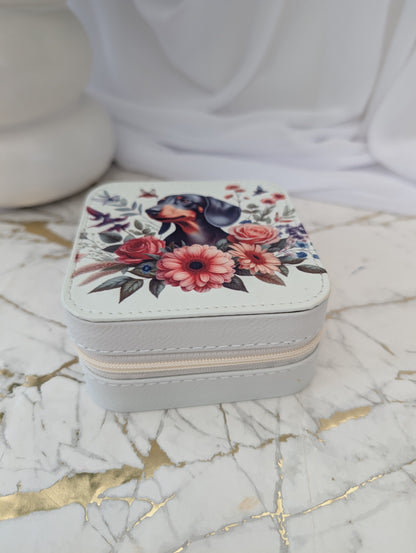 Jewelry box with floral design and dachshund on a marble surface