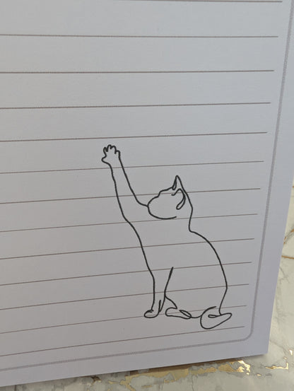 Close up view of kitten line drawing on lined paper