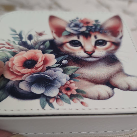 Cream faux leather travel jewellery box with kitten design - shown opening box to view inside compartments with jewellery