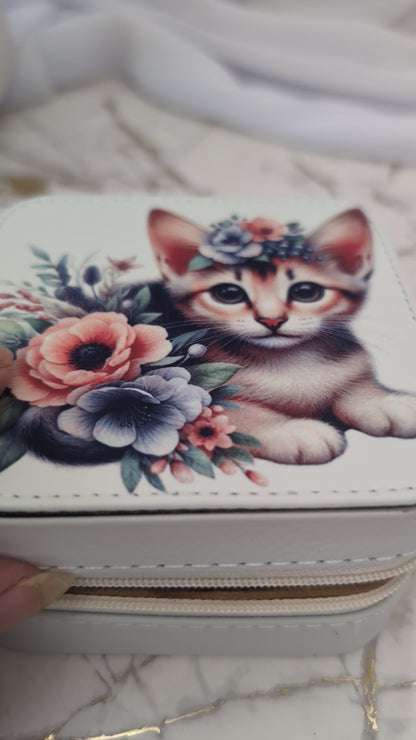 Cream faux leather travel jewellery box with kitten design - shown opening box to view inside compartments with jewellery