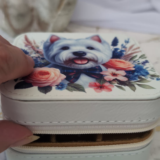 Someone opening the westie travel jewellery box to show jewellery inside the box