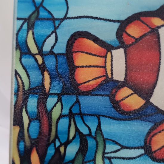 Video showing Clownfish stained glass effect toughened glass chopping board by Paws and Glow