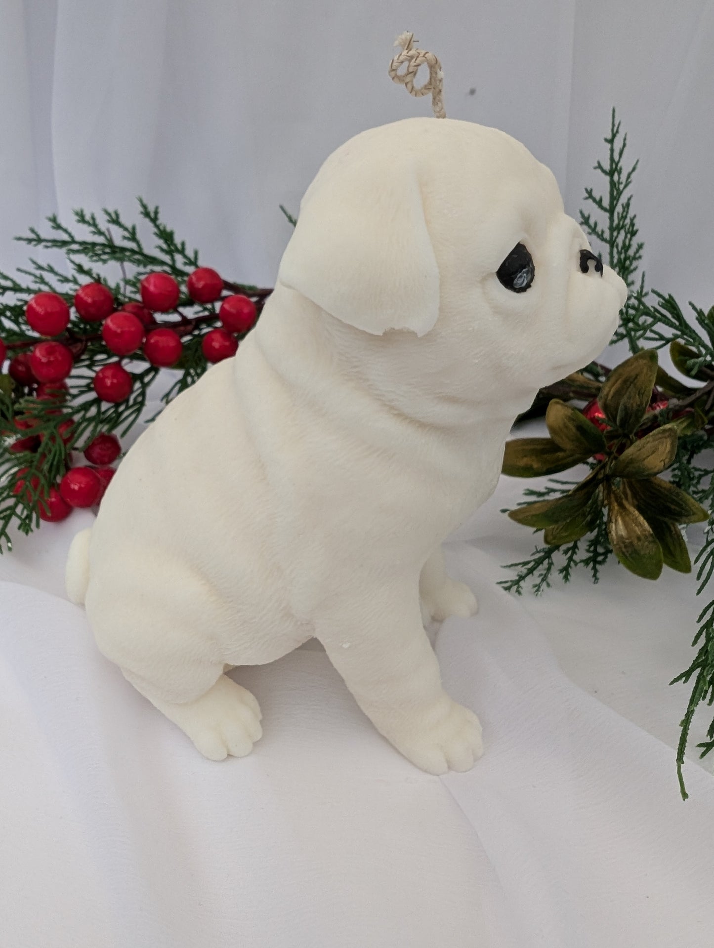 Right profile view of white coconut and rapeseed wax moulded Pug Candle