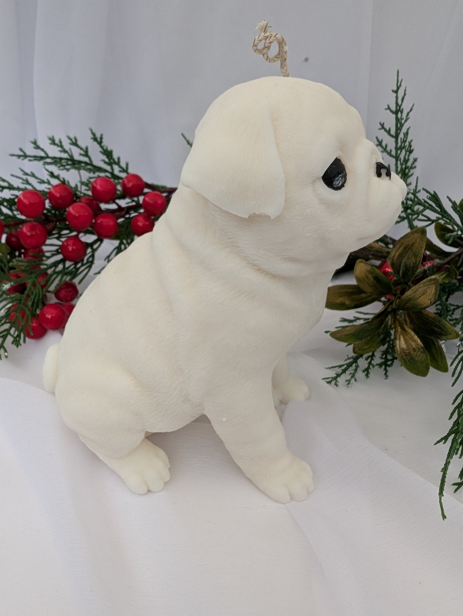 Right profile view of white coconut and rapeseed wax moulded Pug Candle