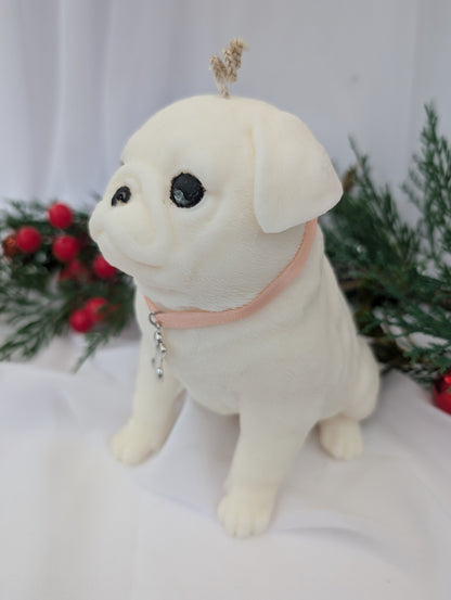 Left side view of white coconut and rapeseed wax moulded Pug Dog candle with ribbon and silver tone bone charm