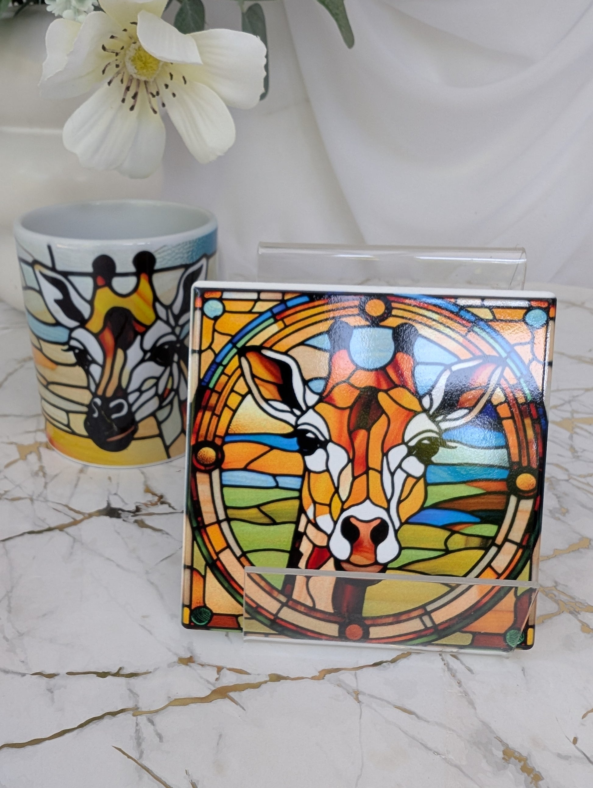 stained glass style ceramic giraffe coaster and matching giraffe mug in the background . Sublimated design won’t rub off. Perfect giraffe lover gift and safari-style kitchenware